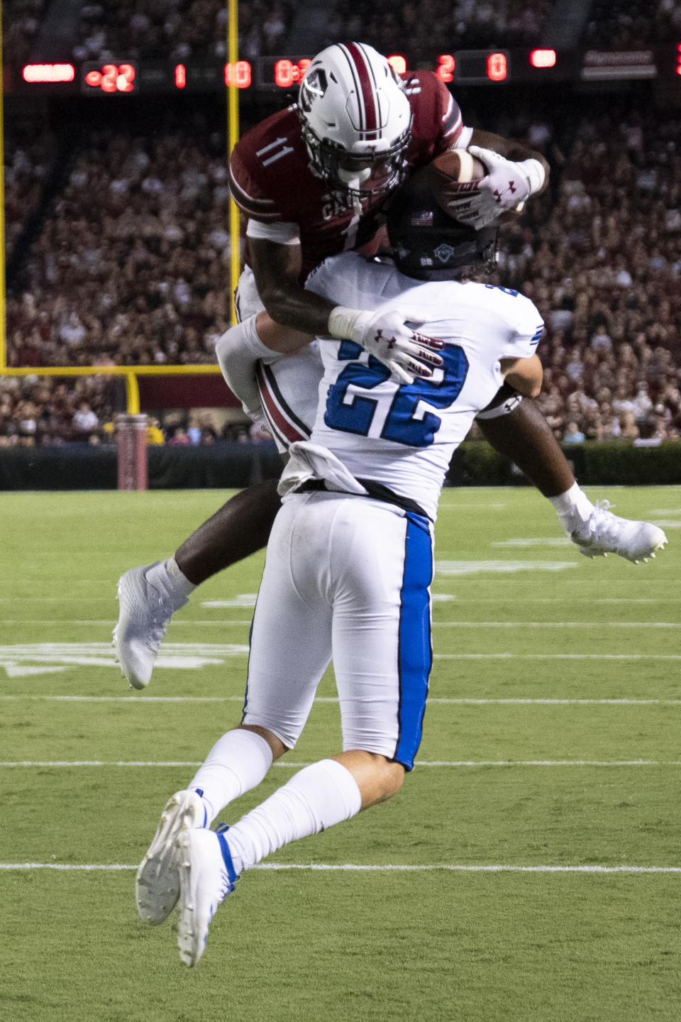 South Carolina running back ZaQuandre White (11) leaps for a touchdown over Eastern Illinoi safety Kaelin Drakeford (22) during the first half of an NCAA college football game on Saturday, Sept. 4, 2021, in Columbia, S.C. (AP Photo/Hakim Wright Sr.)
