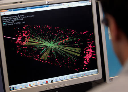 FILE PHOTO: A technician looks at collision at the CMS experiment in the control room of the Large Hadron Collider (LHC) at the European Organisation for Nuclear Research (CERN) near Geneva April 5, 2012. REUTERS/Denis Balibouse/File Photo
