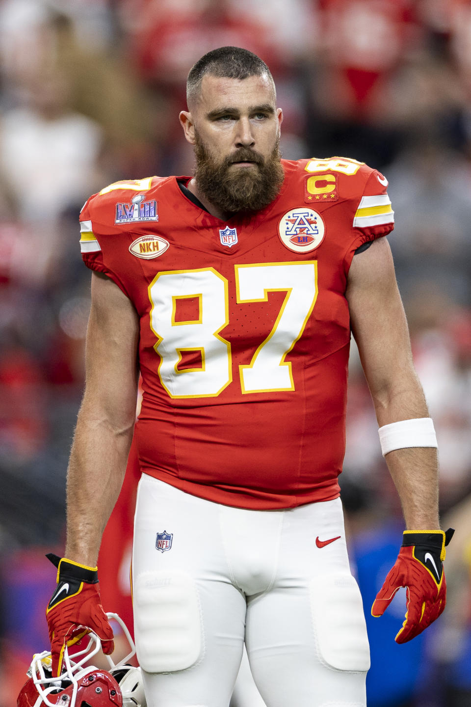 Travis Kelce in his Kansas City Chiefs #87 football uniform, helmet off, on the field