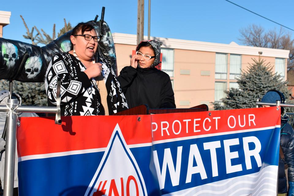 Angeline Cheek, left, a community organizer from the Fort Peck Indian Reservation, speaks about the potential environmental damage from the Keystone XL oil pipeline from Canada during a demonstration in Billings, Montana, in October 2019.