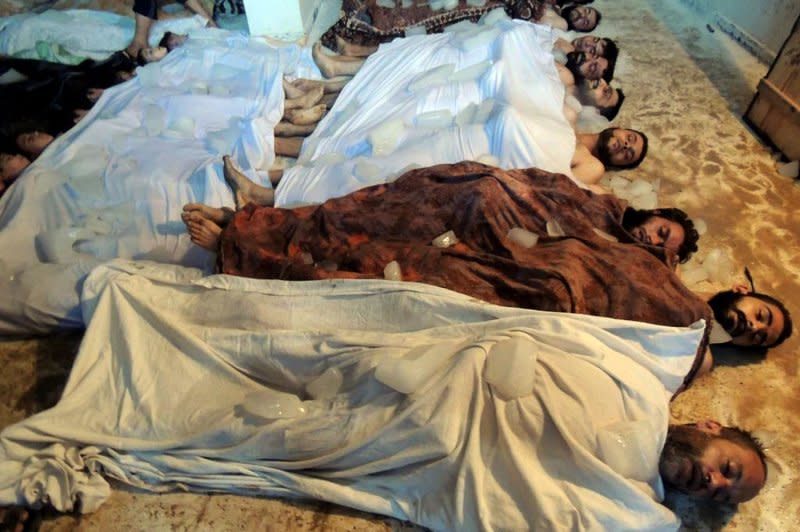 The bodies of men lie in a makeshift morgue in eastern Ghouta, on the outskirts of Damascus, on August 21, 2013. The United States says more than 1,400 died in a large-scale chemical attack by the Assad regime on the rebel-held suburb. File Photo by Diaa El Din/UPI