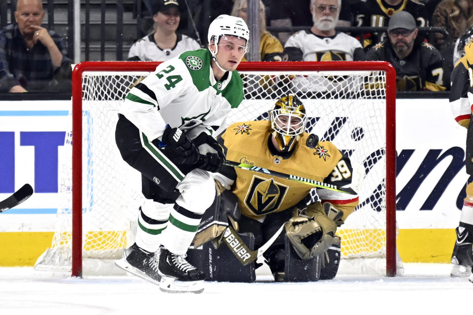 Dallas Stars center Roope Hintz (24) and Vegas Golden Knights goaltender Laurent Brossoit (39) watch the puck during the second period of an NHL hockey game Saturday, Feb. 25, 2023, in Las Vegas. (AP Photo/David Becker)