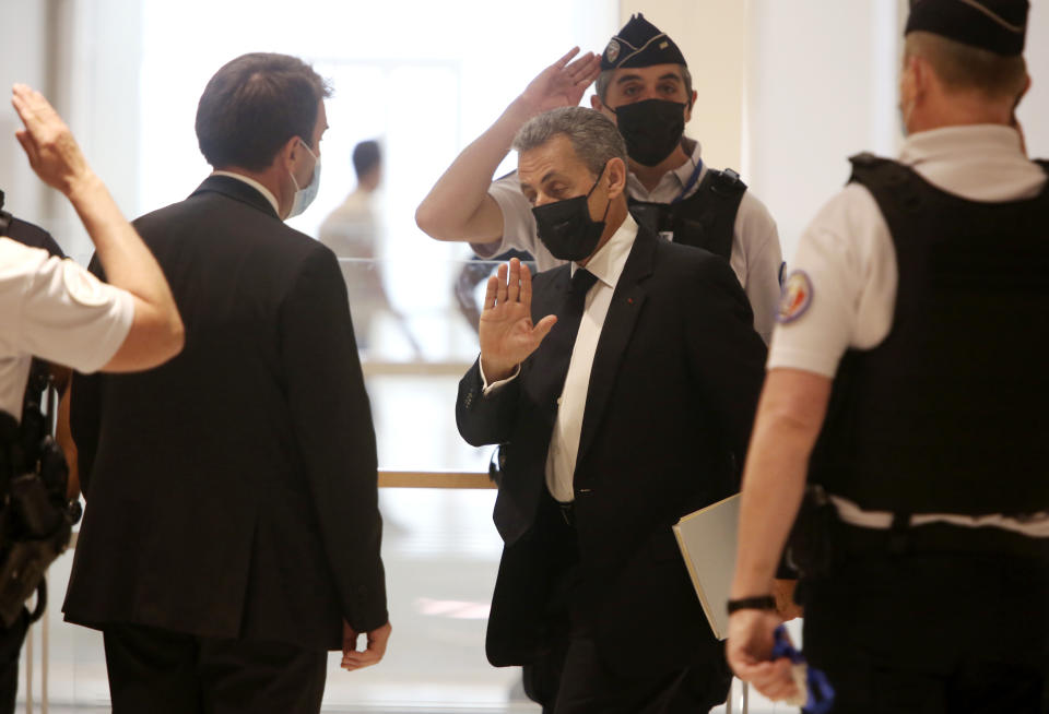 FILE - In this June 15, 2021 file photo, former French President Nicolas Sarkozy, center right, arrives at the court room in Paris. The trial of former French President Nicolas Sarkozy concludes Tuesday in Paris, after a month during which the court sought to determine whether he broke laws on campaign financing in his unsuccessful 2012 re-election bid. (AP Photo/Rafael Yaghobzadeh, File)