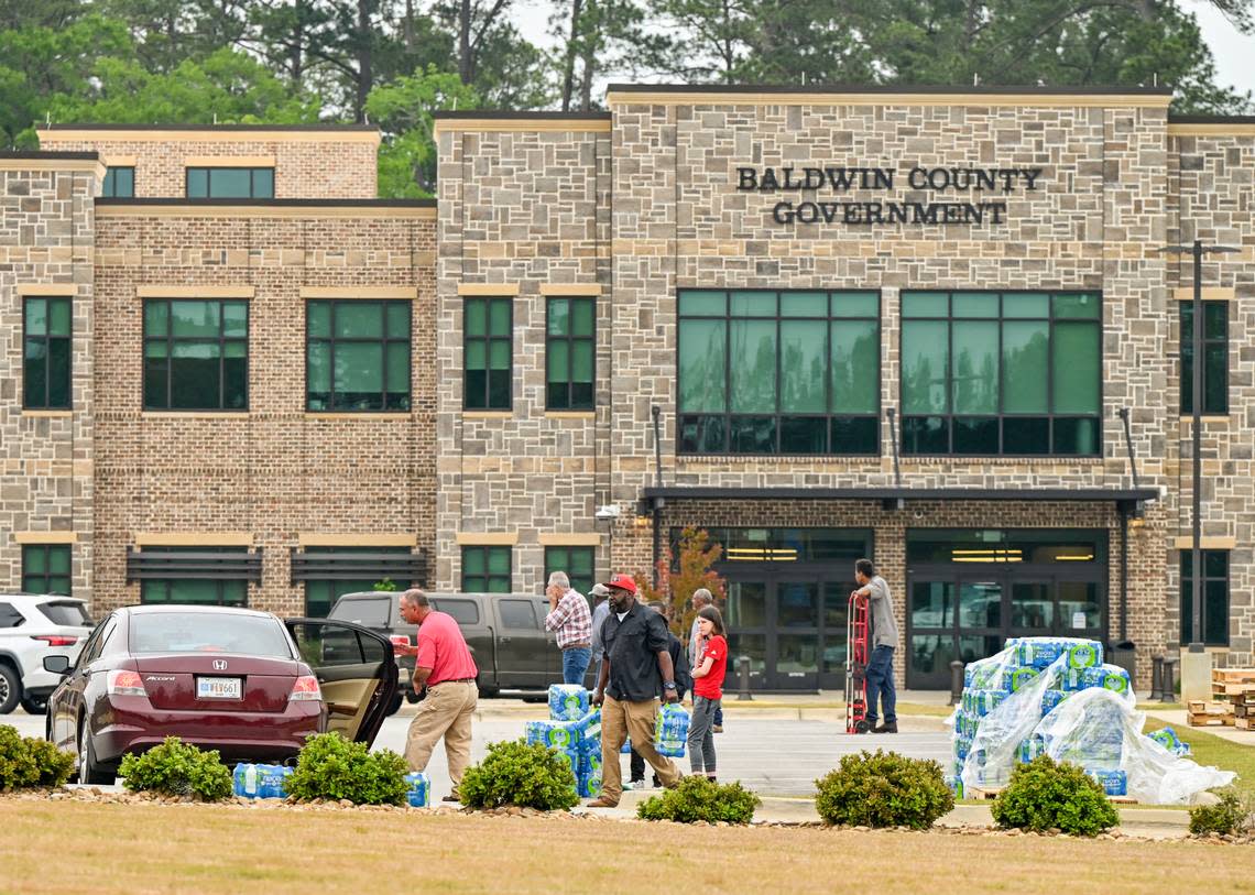 Volunteers and city workers hand out cases of water at the Baldwin County Government Center in Milledgeville Thursday afternoon. The city gave out 864 cases of drinkable water Wednesday night.
