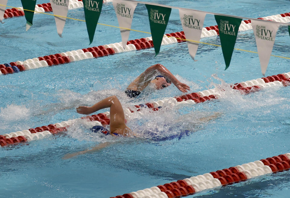 Pennsylvania's Lia Thomas, top, crosses paths with teammate Anna Sofia Kalandadze on the way to winning the 500-yard freestyle final at the Ivy League women's swimming and diving championships at Harvard University, Thursday, Feb. 17, 2022, in Cambridge, Mass. Thomas, who is transitioning to female, is swimming for the Penn women's team. (AP Photo/Mary Schwalm)