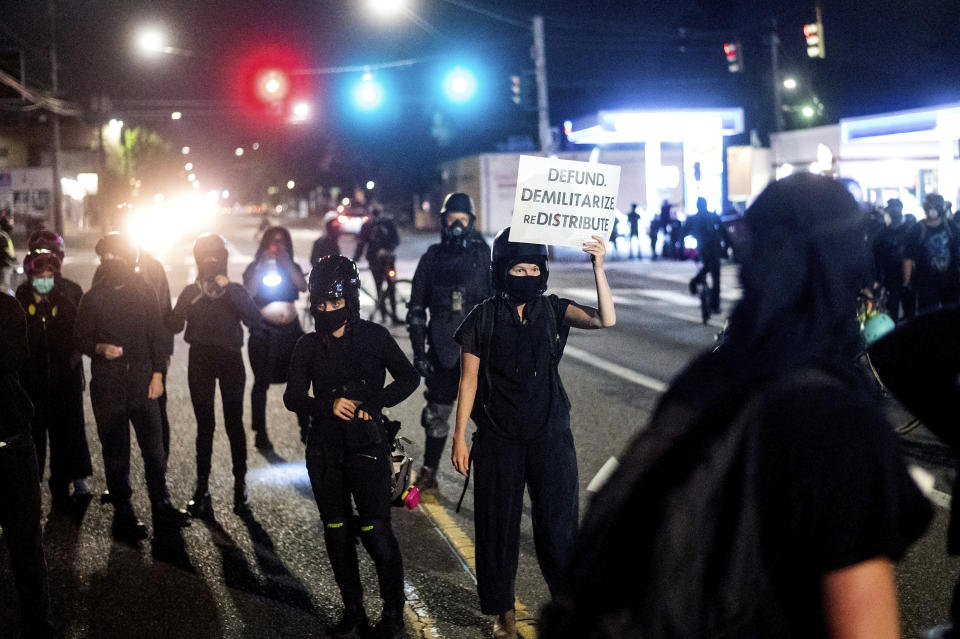 Anti-police protesters rally outside the Portland Police Association building on Friday, Sept. 4, 2020, in Portland, Ore. This weekend Portland will mark 100 consecutive days of protests over the May 25 police killing of George Floyd.  (AP Photo/Noah Berger)