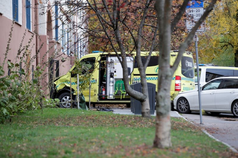 A damaged ambulance stands next to a building after an armed man who stole the vehicle was apprehended by police in Oslo