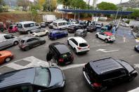 Cars queue to fill their fuel tanks at a petrol station in Nice