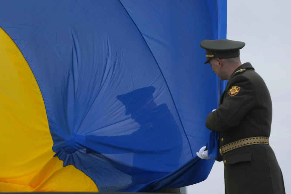 Ukrainian honor guard soldiers take part in a national flag-raising ceremony during a commemorative event on the anniversary of the liberation of the territories from the Russian troops, in Bucha, on the outskirts of Kyiv, Ukraine, Friday, March 31, 2023. (AP Photo/Efrem Lukatsky)