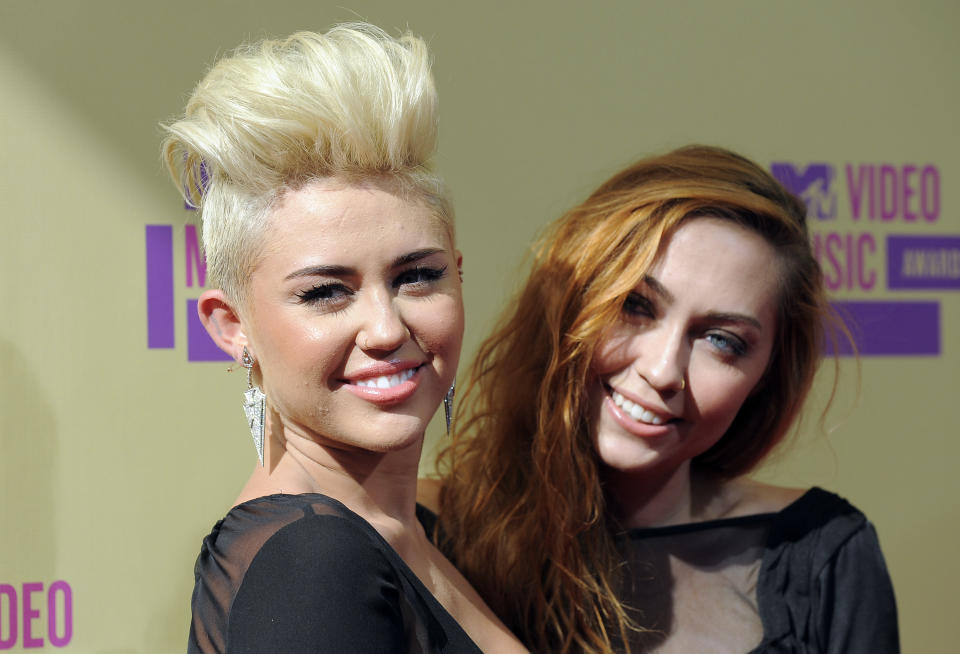 Miley Cyrus and her sister Brandi Cyrus attend the MTV Video Music Awards on Thursday, Sept. 6, 2012, in Los Angeles. (Photo by Jordan Strauss/Invision/AP)