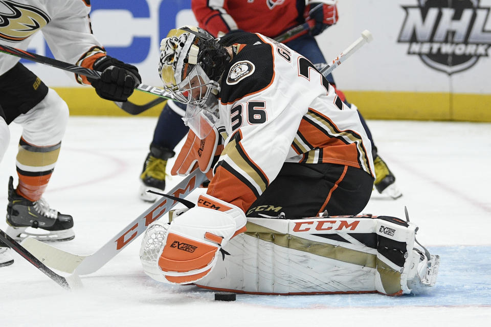 Anaheim Ducks goaltender John Gibson (36) reaches for the puck during the second period of an NHL hockey game against the Washington Capitals, Monday, Nov. 18, 2019, in Washington. (AP Photo/Nick Wass)