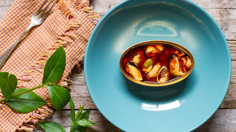 can of mussels on plate