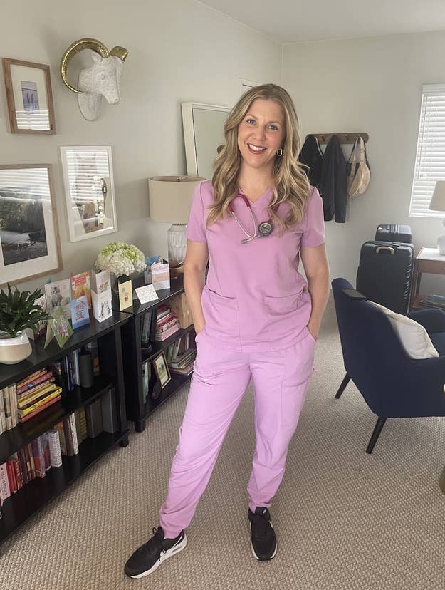 Woman in scrubs with a stethoscope, standing in an office setting