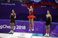 Gold medallist Alina Zagitova, an Olympic Athlete from Russia, celebrates between silver medallist Evgenia Medvedeva, an Olympic Athlete from Russia, and bronze medallist Kaetlyn Osmond of Canada in the women's free skate final. REUTERS/Phil Noble