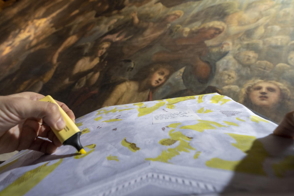 Restorer Alberto Marcon maps signs of decay on the 7,45x24,65-meter oil on canvas 'Il Paradiso' completed in 1592 by Venetian painters Jacopo Robusti, also known as Tintoretto, and his son Domenico in the Maggior Consiglio Hall inside Palazzo Ducale in Venice, northern Italy, Wednesday, Dec. 6, 2022. The Doge's Palace, the heart of the political life of the Venetian Republic for centuries, is undergoing a major reconnaissance of its conservation status by the Fondazione Musei Civici of the municipality of Venice that includes the urgent restoration of its paintings and infrastructures, which is expected to be completed in the summer of 2023. (AP Photo/Domenico Stinellis)