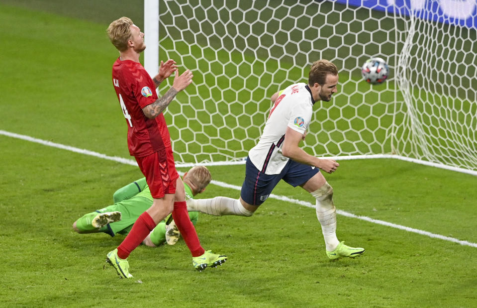 England's Harry Kane, right, reacts after scoring his team's second goal during the Euro 2020 soccer championship semifinal between England and Denmark at Wembley stadium in London, Wednesday, July 7, 2021. (Justin Tallis/Pool Photo via AP)