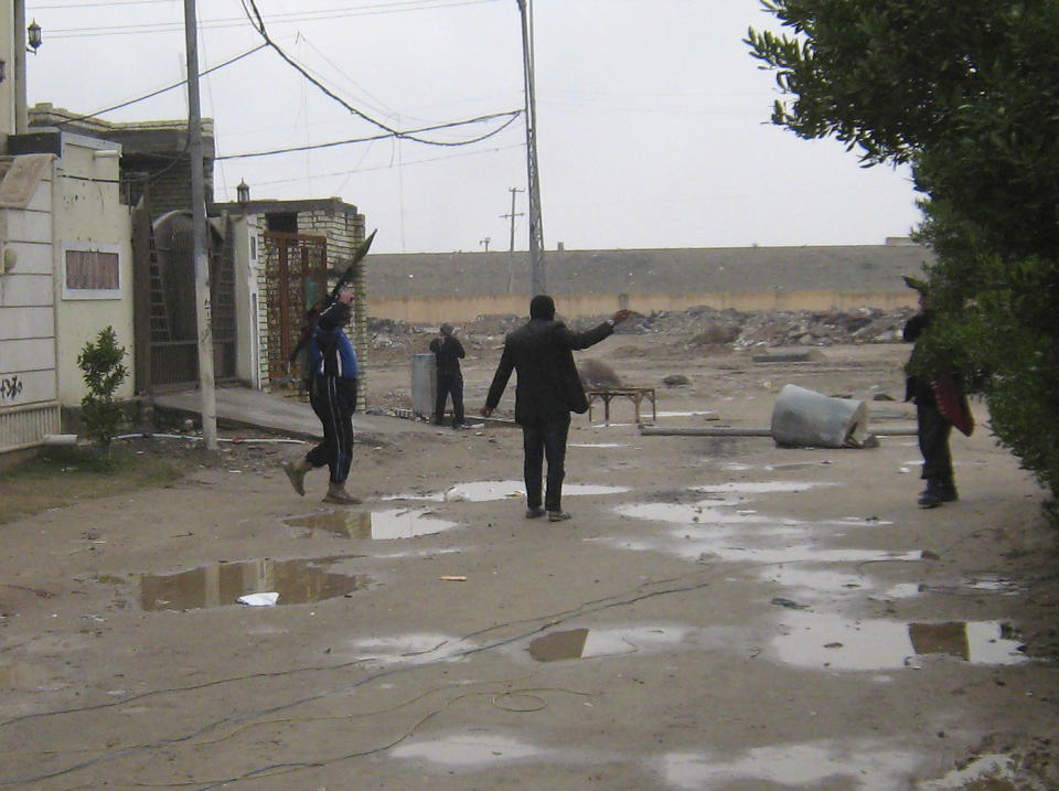 In this Saturday, Jan. 11, 2014 photo, gunmen patrol in Fallujah, 65 kilometers (40 miles) west of Baghdad, Iraq. Fighting between security forces and al-Qaida-linked militants in Iraq's Sunni-dominated Anbar province has killed at least 60 people over the past two weeks, an official said Saturday. International observers have warned of shortages of food, fuel and other necessities, particularly in Fallujah. United Nations records show that more than 11,000 families have been uprooted by the fighting. (AP Photo)