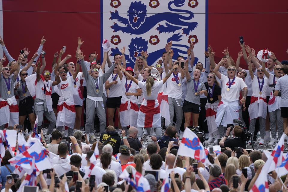 England players celebrate on stage at an event at Trafalgar Square in London, Monday, Aug. 1, 2022. England beat Germany 2-1 and won the final of the Women's Euro 2022 on Sunday. (AP Photo/Frank Augstein)