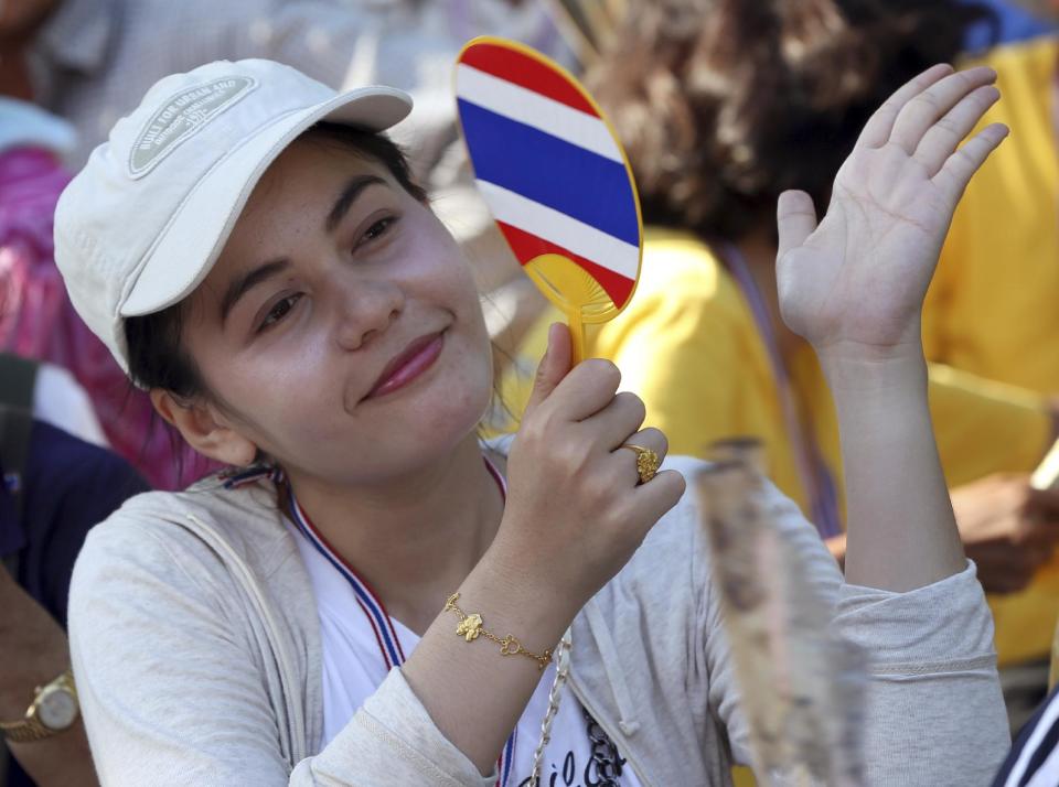 An anti-government protester cheers to a speech during a rally outside the Parliament in Bangkok, Thailand Monday, May 12, 2014. Emboldened by the removal of Thailand's prime minister, anti-government protesters withdrew from the city's main park Monday and marched to the vacated prime minister's office compound - where the protest leader has pledged to set up his new office. (AP Photo/Apichart Weerawong)