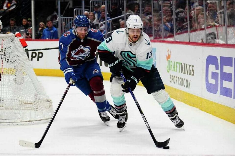 Seattle Kraken left wing Brandon Tanev (13) is hounded by Colorado Avalanche defenseman Devon Toews (7) during the second period of Game 1 of a first-round Stanley Cup playoff series Tuesday, April 18, 2023, in Denver.