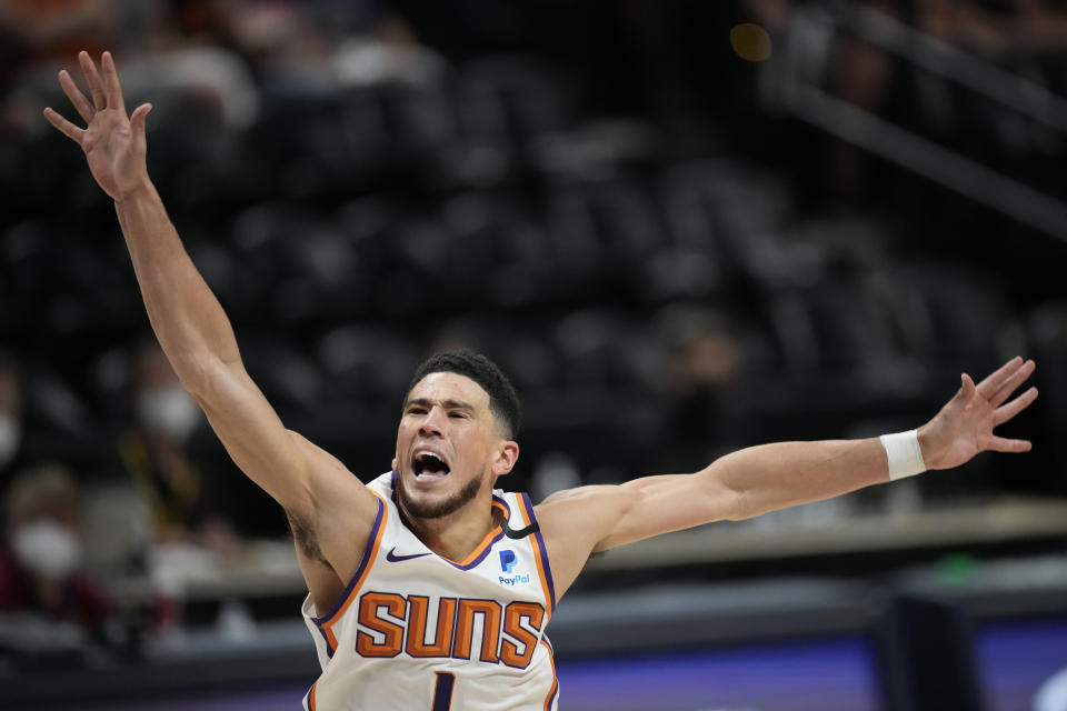 Phoenix Suns guard Devin Booker reacts after he was fouled while driving to the rim in the first half of Game 4 of an NBA second-round playoff series againstt he Denver Nuggets Sunday, June 13, 2021, in Denver. (AP Photo/David Zalubowski)