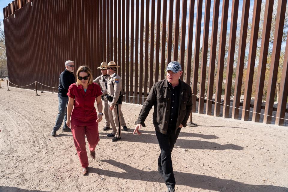 U.S. Sens. Kyrsten Sinema, I-Ariz., left, and Mark Kelly, D-Ariz., right, visit the U.S.-Mexico border in Somerton, Ariz., near the Cocopah Indian Reservation boundary on Jan. 10, 2023.