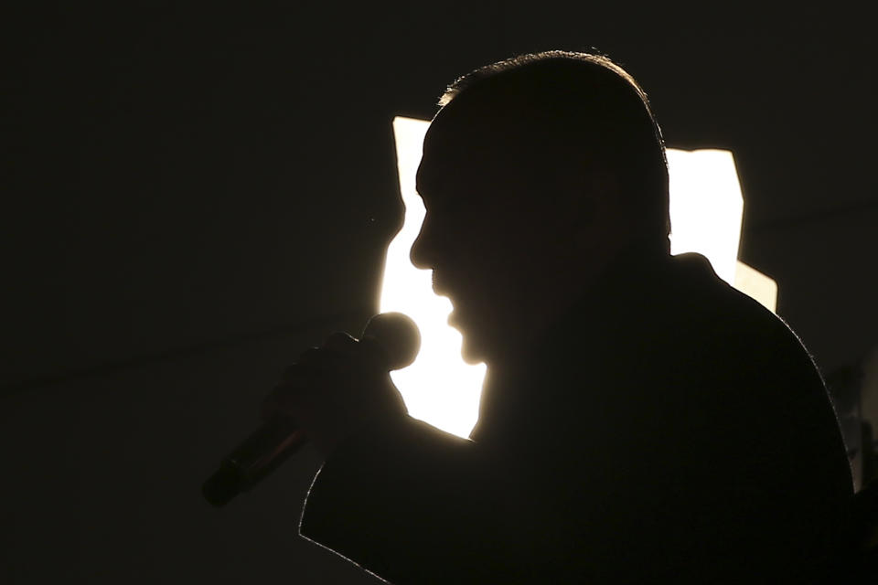 Turkey's President and ruling Justice and Development Party, or AKP, leader Recep Tayyip Erdogan is silhouetted as he addresses his supporters after the results of the local elections were announced in Ankara, Turkey, early Monday, April 1, 2019. Erdogan's ruling party has declared victory in the race for mayor of Istanbul, even though the result in Turkey's most populous city and commercial hub is too close to call. State broadcaster TRT says former Prime Minister Binali Yildirim received 48.71 percent of the votes in Sunday's municipal elections while the opposition's candidate, Ekrem Imamoglu, got 48.65 percent. (AP Photo/Ali Unal)