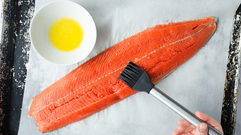 brushing salmon with melted butter