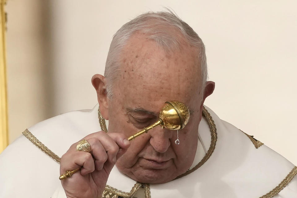 Pope Francis asperses holy water as he celebrates Easter mass in St. Peter's Square at the Vatican, Sunday, March 31, 2024. (AP Photo/Andrew Medichini)