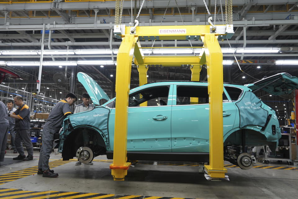 Workers assemble a car at a Vinfast factory in Hai Phong, Vietnam, on Sept. 29, 2023. Vietnamese automaker Vinfast has plunged right into the crowded and hypercompetitive U.S. auto market, gambling that if it can sell its electric vehicles to finicky Americans, it can succeed anywhere. So far, that gamble has yet to pay off. (AP Photo/Hau Dinh)