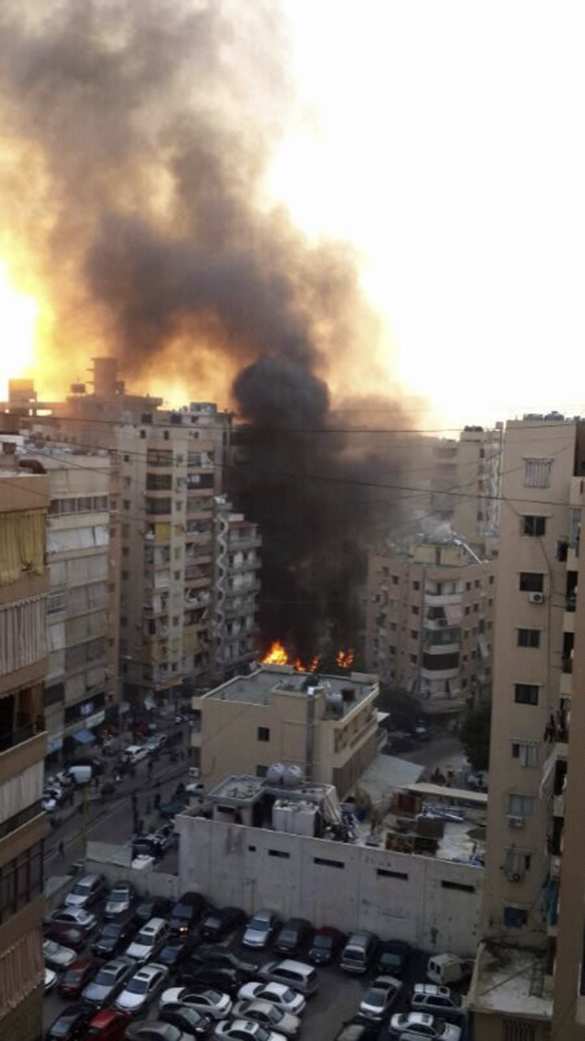 Fire and smoke is seen at the site of the explosion in Beirut's southern suburbs