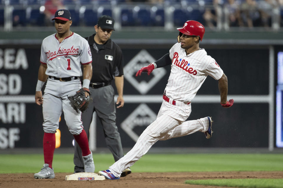 Philadelphia Phillies' Nick Williams, right, comes into second as Washington Nationals second baseman Wilmer Difo, left, looks on during the ninth inning of a baseball game, Tuesday, Aug. 28, 2018, in Philadelphia. The Nationals won 5-4. (AP Photo/Chris Szagola)