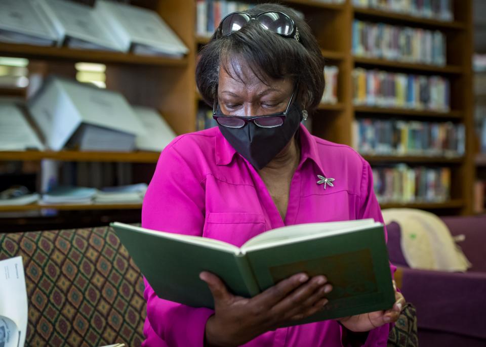 Antoinette Pete looks at yearbooks with from the early 1970s at Crowley High School with Jimmy Meche. Pete was a ninth-grader and Meche her assistant principal when the school was integrated in 1971. Monday, April 26, 2021.