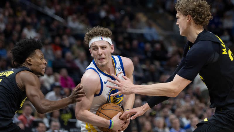 Golden State Warriors guard Brandin Podziemski (2) is blocked by Utah Jazz forward Lauri Markkanen (23) and Utah Jazz guard Collin Sexton (2) during a game at the Delta Center in Salt Lake City on Monday, Feb. 12, 2024.