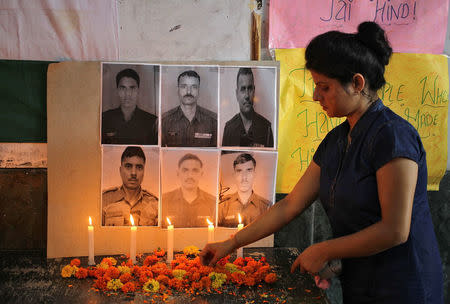 A woman lights candles during a vigil for the soldiers who were killed in Sunday’s attack at an Indian army base in Kashmir's Uri, at a school in Jammu, September 20, 2016. REUTERS/Mukesh Gupta