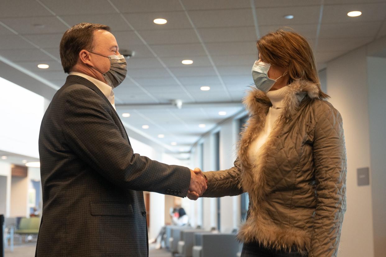 Sam Miller, president/CEO of Crusader Community Health, greets U.S. Rep. Cheri Bustos on Friday, January 28, 2022.