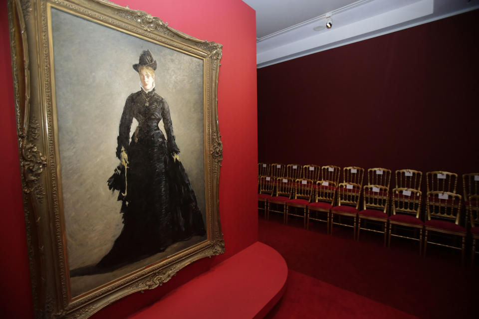 The painting by Eduard Manet, The Parisian, (1875), hangs on the mirrored catwalk during the press day of the Impressionism Fashion exhibition in at the Orsay museum in Paris, Friday, Sept. 21, 2012. To coincide with Paris Fashion week, a new and highly original exhibit called "Impressionism and Fashion" opens at the Musee d'Orsay. It uses famous works of art to explore how at the dawn of impressionism, and as an emblem of "modernite" fashion, and how people dressed, became one of the main themes in art. The exhibition will open September 25, 2012 and last till January 2013. (AP Photo/Michel Euler)