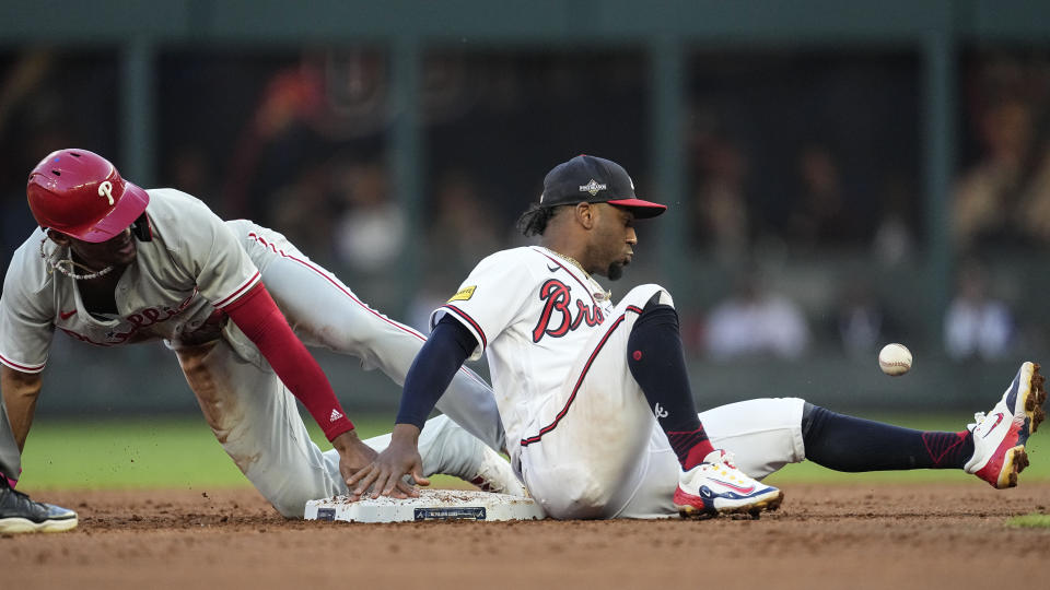 Philadelphia Phillies center fielder Johan Rojas (18) steals second base against Atlanta Braves second baseman Ozzie Albies (1) in the second inning of Game 2 of a baseball NL Division Series, Monday, Oct. 9, 2023, in Atlanta. (AP Photo/John Bazemore)