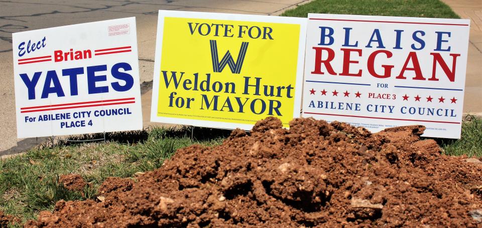 Campaign signs for the three pro-business candidates at a street corner where work was being done off Sayles Boulevard.