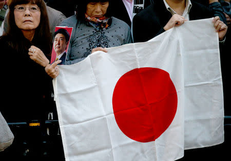 Supporters of Japan's Prime Minister Shinzo Abe, who is also ruling Liberal Democratic Party leader, wait for him at an election campaign rally in Tokyo, Japan October 18, 2017. REUTERS/Toru Hanai