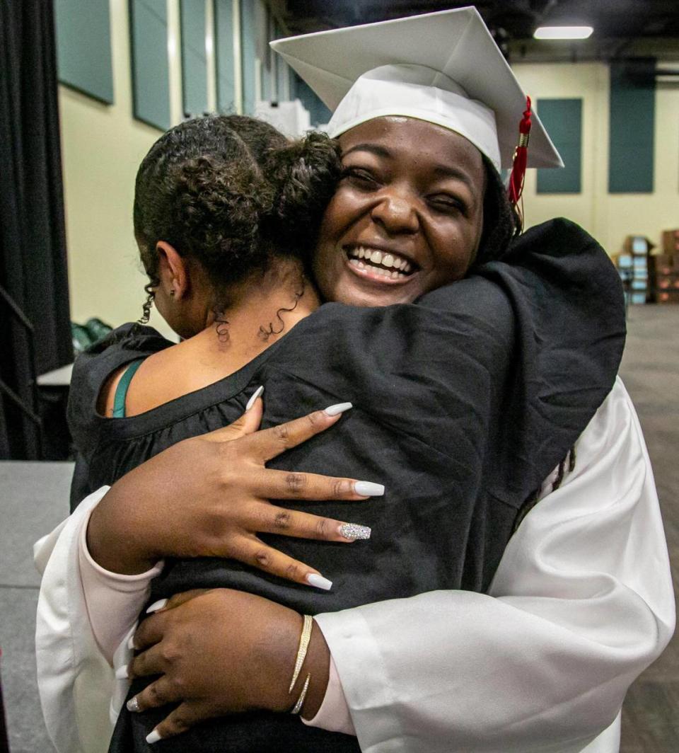 Ashley Adirika hugs a friend after receiving her diploma during Miami Beach High commencement ceremonies in the Watsco Center at the University of Miami.