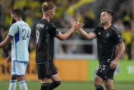 Nashville SC forward Sam Surridge (9) and defender Taylor Washington (23) celebrate the team's 4-1 win against CF Montréal after an MLS soccer match Saturday, May 4, 2024, in Nashville, Tenn. (AP Photo/George Walker IV)