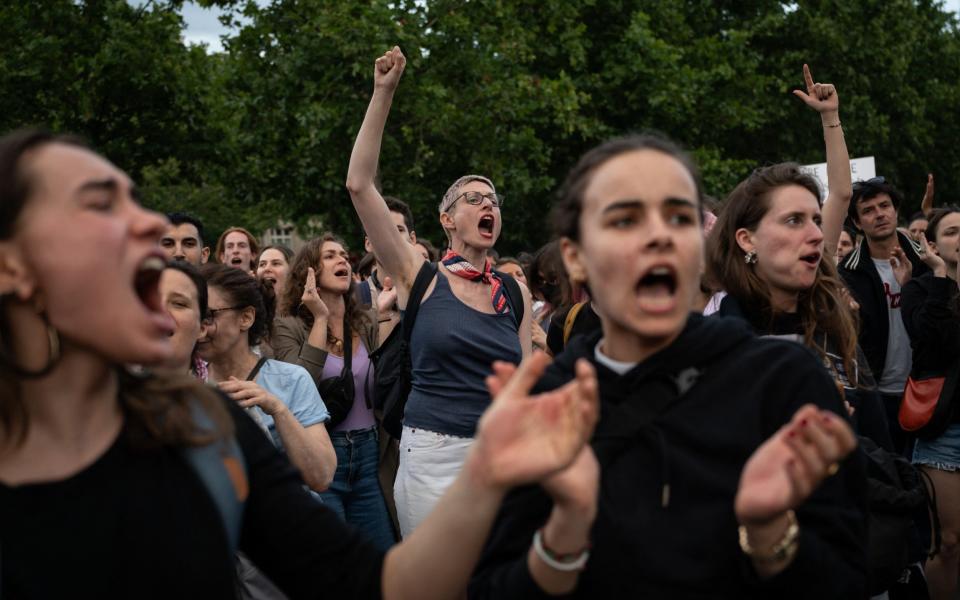 Demonstrators shout slogans in Place de la Republique