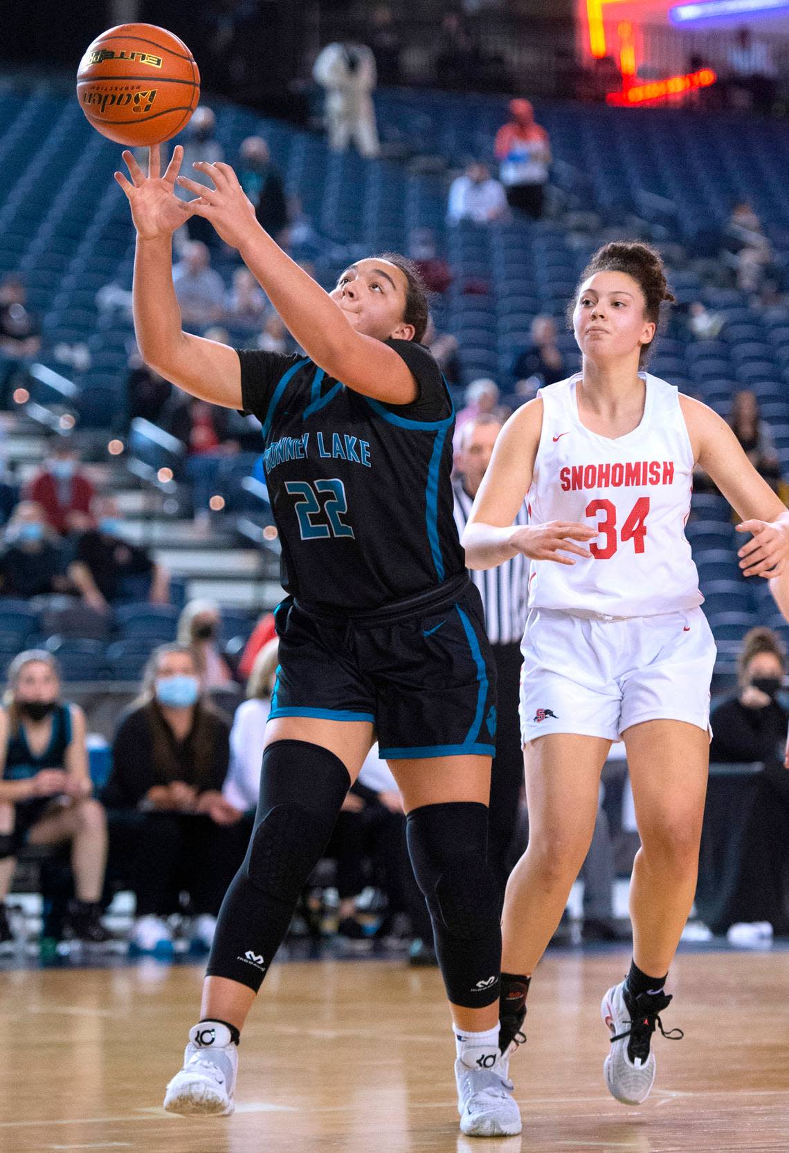 Bonney Lake post Jazmyn Shipp reaches for a rebound in front of Snohomish’s Tyler Gildersleeve-Stiles during Wednesday evening’s opening-round game of the WIAA 3A Girls Basketball State Championships tournament in the Tacoma Dome in Tacoma, Washington, on Wednesday, March 2, 2022. Snohomish won the game, 46-44.