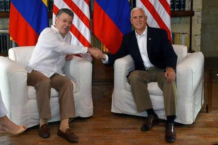 Colombia's President Juan Manuel Santos greets U.S. Vice President Mike Pence after his arrival in Cartagena, Colombia August 13, 2017. Colombian Presidency/Handout via REUTERS