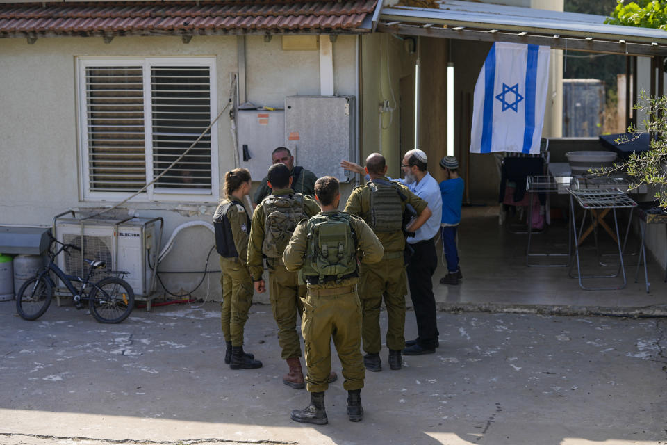 Israeli soldiers inspect a damaged house after it was hit by a rocket fired from the Gaza Strip, in Sderot, Israel, Wednesday, May 10, 2023. (AP Photo/Ohad Zwigenberg)