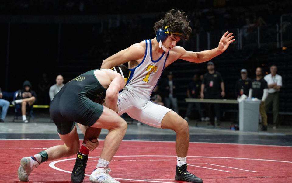 Turlock’s Jeremiah Bertalotto spins away from Enzo Gallo of Placer during the 138-poind title match in the Sac-Joaquin Section Masters Wrestling Championships at Stockton Arena in Stockton, Calif., Saturday, Feb. 17, 2024. Bertalotto won by decision 5-1.