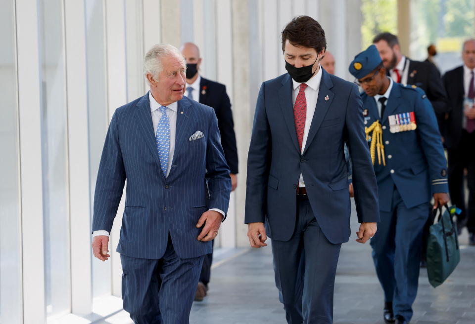 Britain's Prince Charles and Canadian Prime Minister Justin Trudeau walk together to meet with Canada's Minister of Environment and Climate Change Steven Guilbeault on the second day of the Canadian 2022 Royal Tour, in Ottawa, Ontario, Canada May 18, 2022. REUTERS/Blair Gable