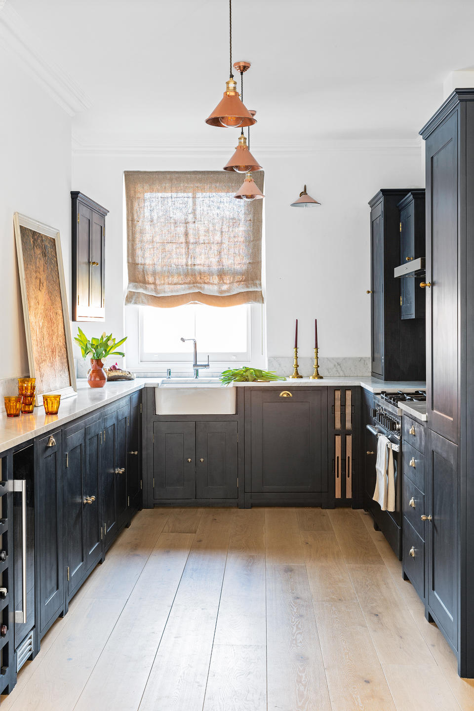 kitchen with blue cabinetry and wooden floor with white ceiling and walls