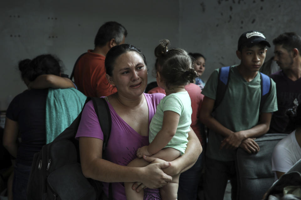 Detained migrants stand together in a storage room at the back of the Azteca Hotel where they tried to hide from Mexican immigration agents conducting a raid in Veracruz, Mexico, Thursday, June 27, 2019. Under increasing U.S. pressure to reduce the flow of hundreds of thousands of Central Americans through Mexican territory, Mexico's government has stepped up enforcement. (AP Photo/Felix Marquez)